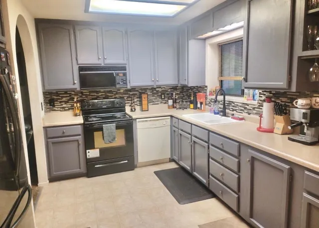 a utility room with sink dryer and washer