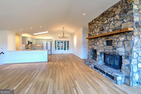 a view of kitchen with furniture and wooden floor