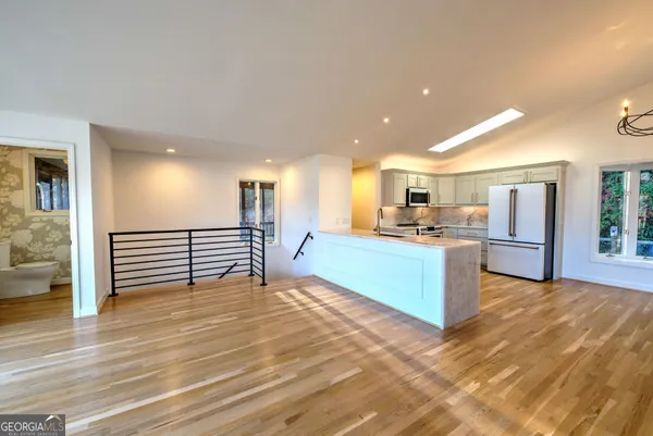 a view of a kitchen with a sink and a refrigerator