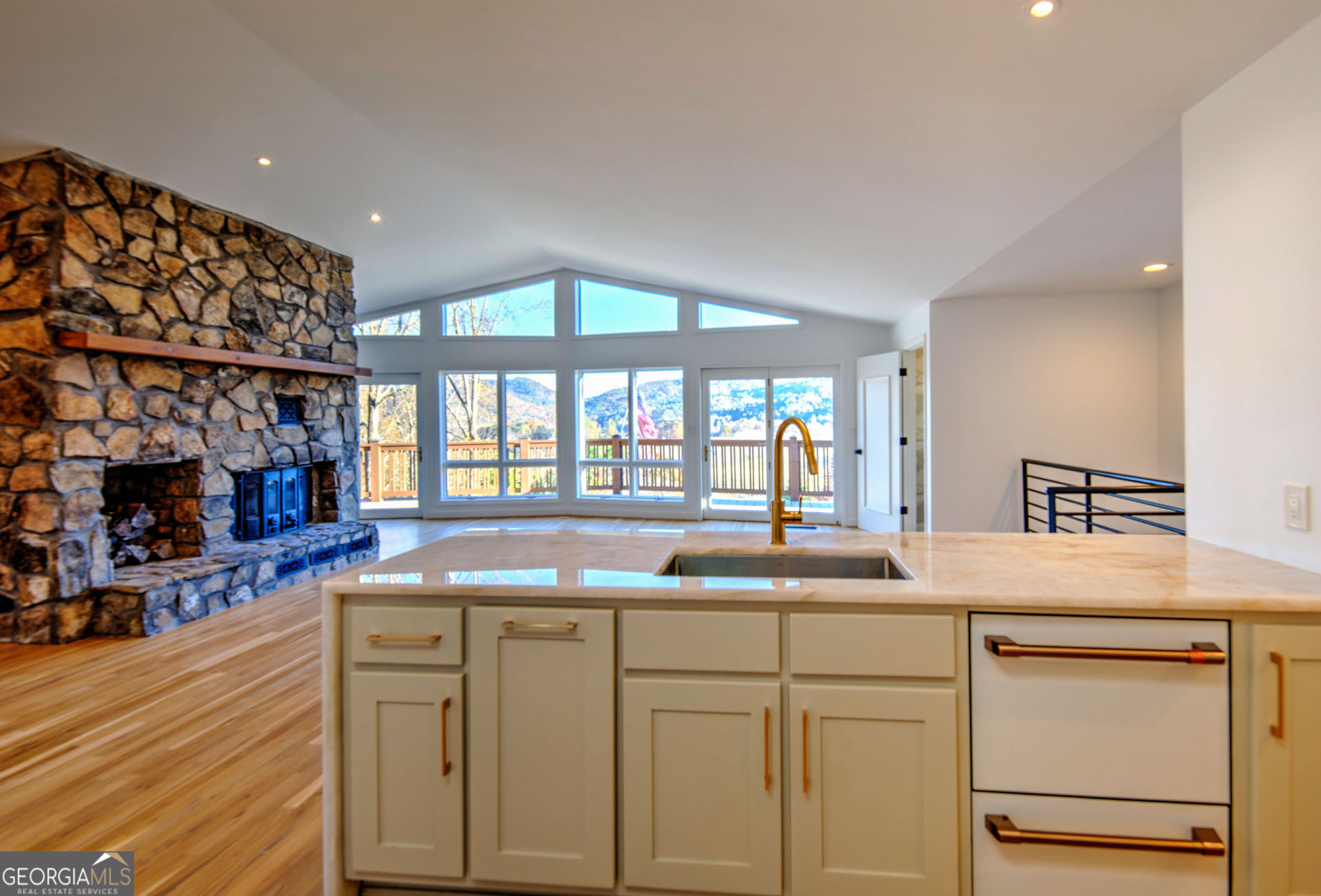 5019 Wolffork Road Rabun Gap, GA 30568 - Photo 17 of 52 a kitchen with cabinets and chandelier