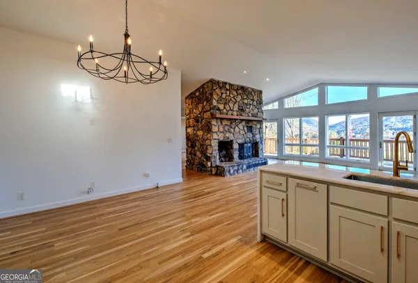 a view of kitchen and sink with wooden floor