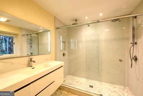 a bathroom with a shower and a sink