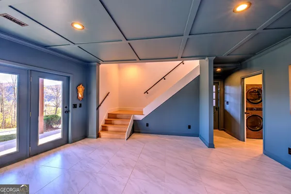 a view of an empty room with a fireplace and window
