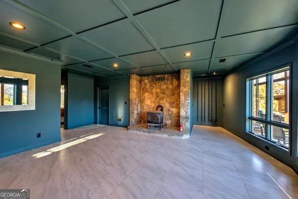 a view of a livingroom with wooden floor and furniture