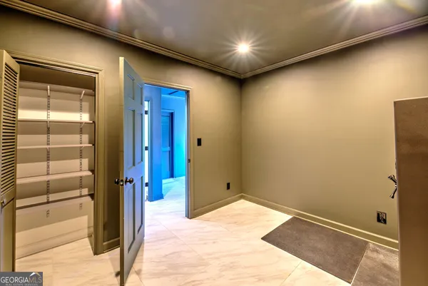 a view of a hallway with a door and wooden floor