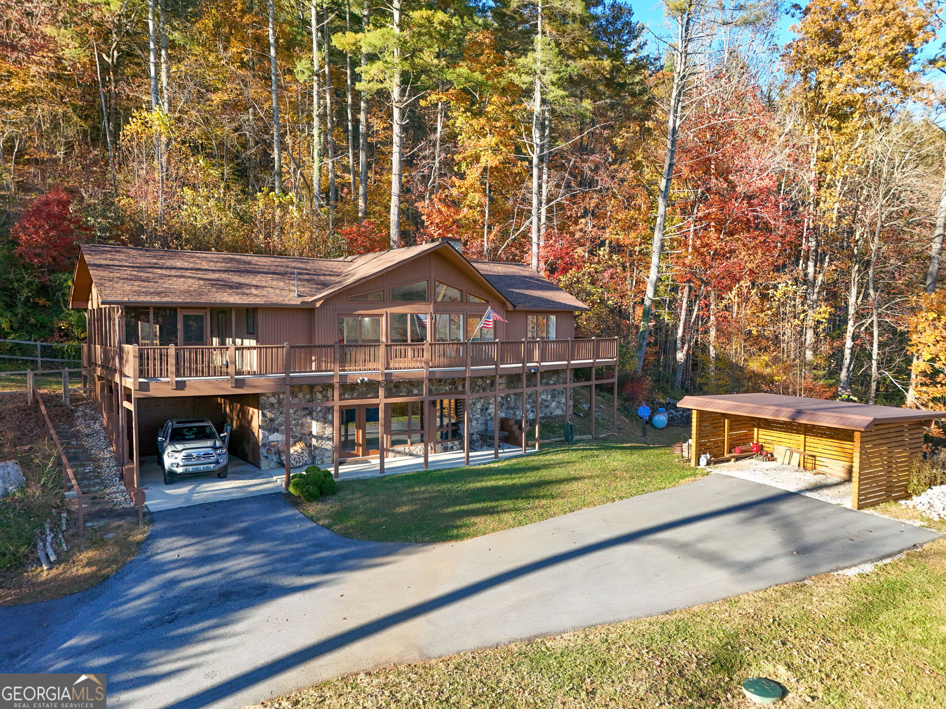 5019 Wolffork Road Rabun Gap, GA 30568 - Photo 7 of 52 a front view of a house with a yard table and chairs