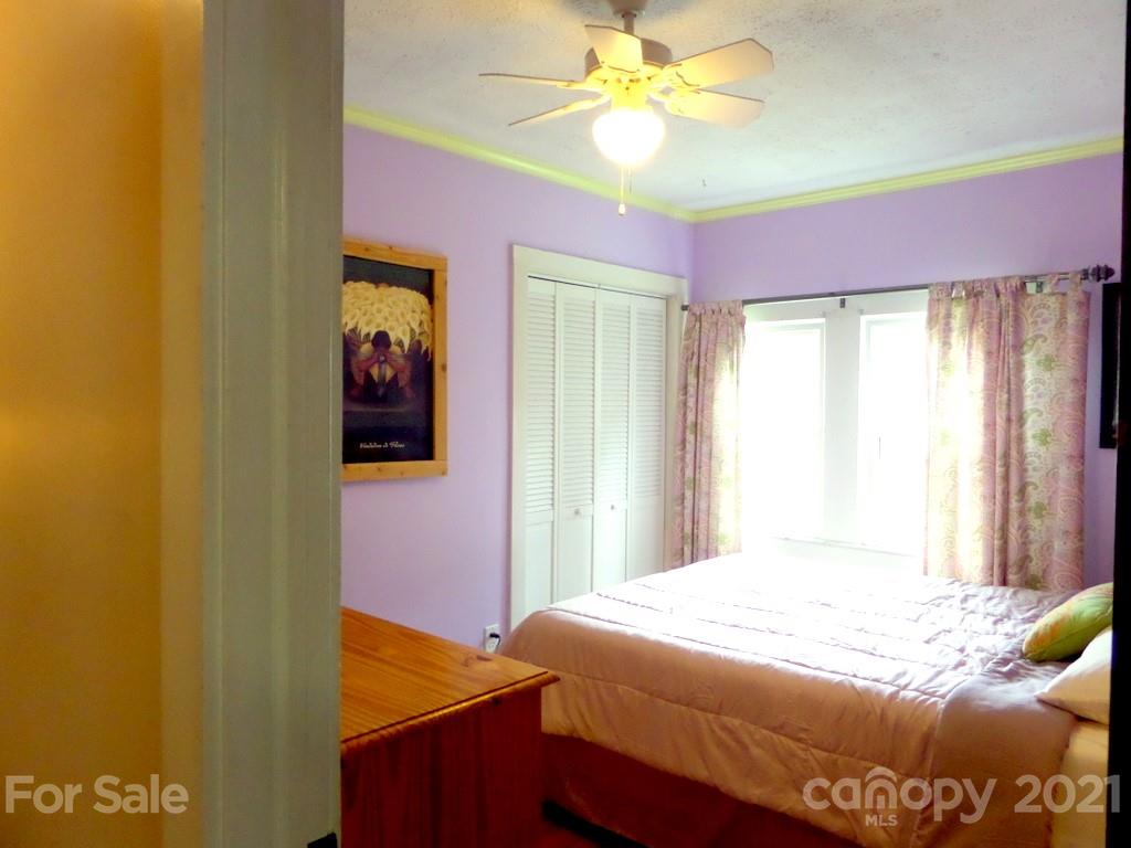 499 Oak Grove Road Flat Rock, NC 28731 - Photo 14 of 18 a bedroom with a bed and a window