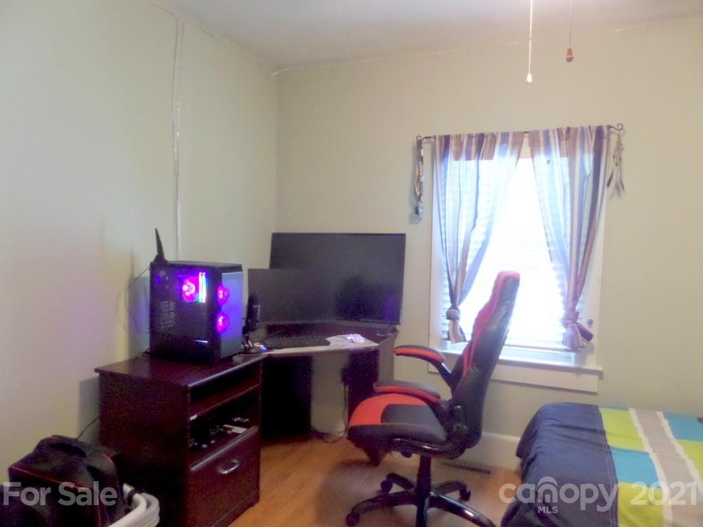 499 Oak Grove Road Flat Rock, NC 28731 - Photo 15 of 18 a view of a workspace with furniture and a window