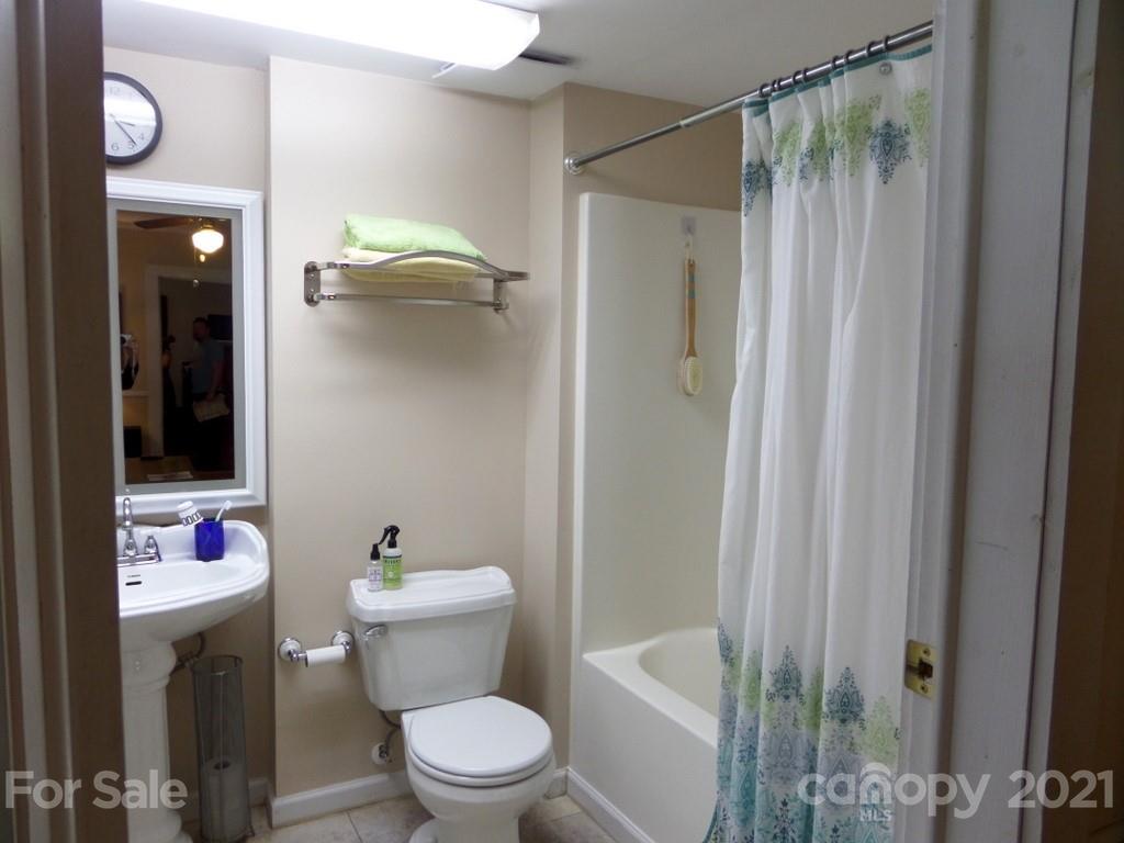 499 Oak Grove Road Flat Rock, NC 28731 - Photo 18 of 18 a bathroom with a toilet and shower