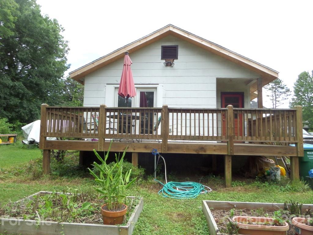 499 Oak Grove Road Flat Rock, NC 28731 - Photo 3 of 18 a view of a house with a deck front of house