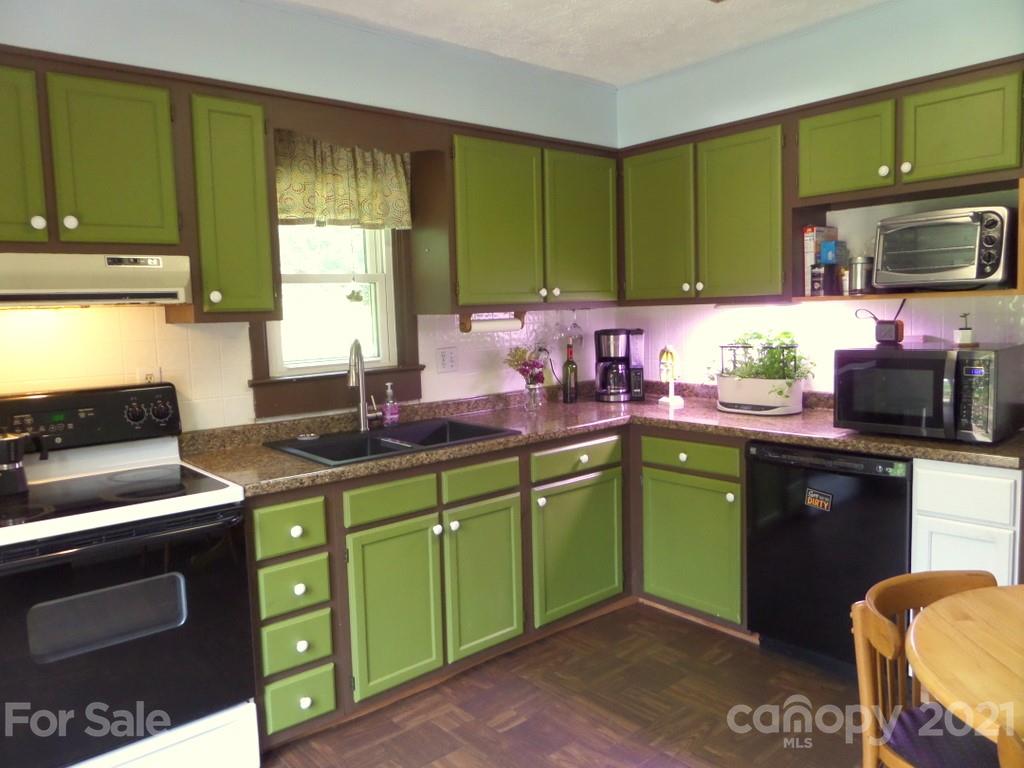 499 Oak Grove Road Flat Rock, NC 28731 - Photo 9 of 18 a kitchen with cabinets and a stove top oven
