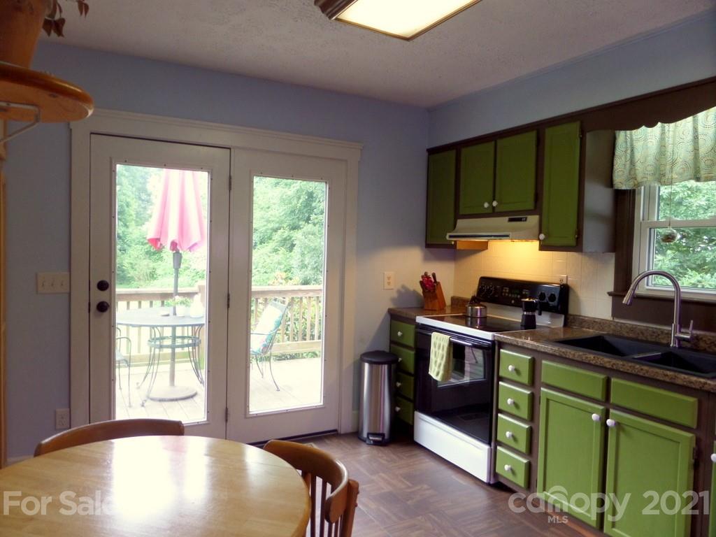 499 Oak Grove Road Flat Rock, NC 28731 - Photo 10 of 18 a kitchen with stainless steel appliances granite countertop sink stove and cabinets