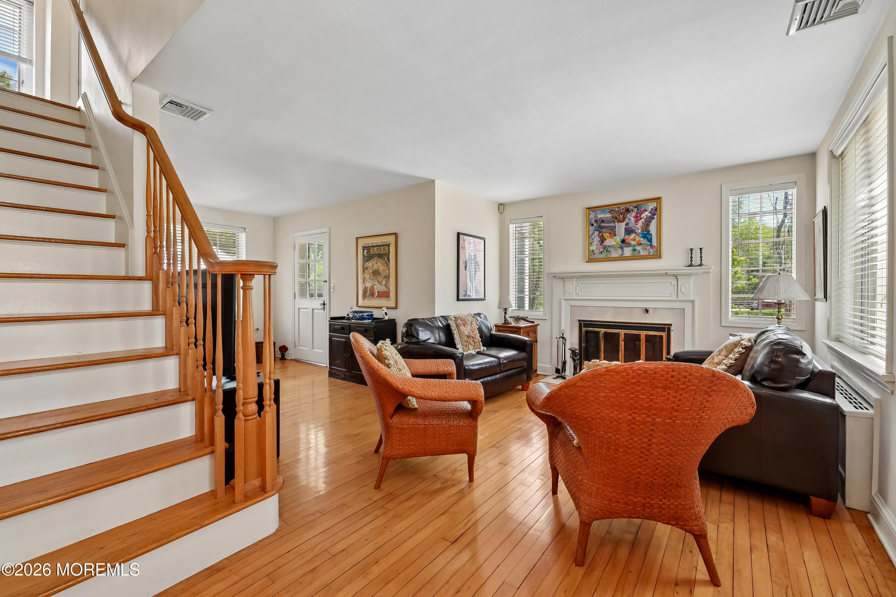 187 Hockhockson Road Colts Neck, NJ 07722 - Photo 22 of 55 a living room with fireplace furniture and a wooden floor