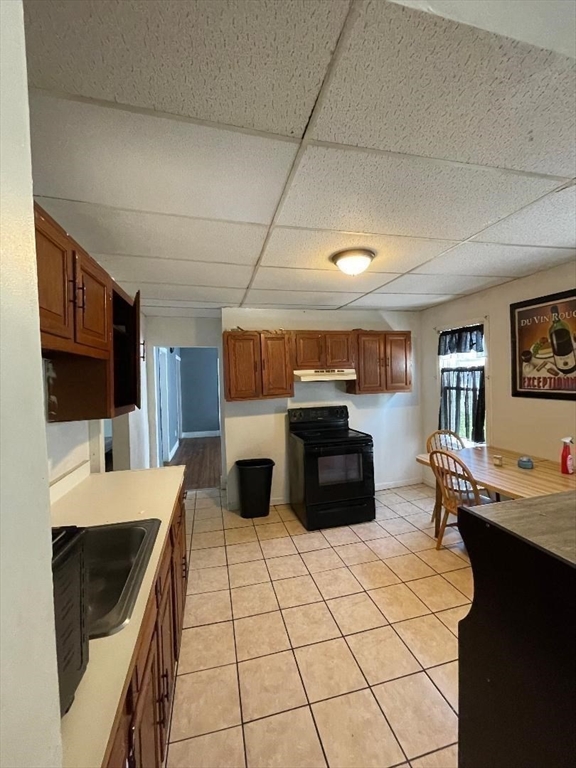 79 Keith Street Springfield, MA 01108 - Photo 18 of 37 a kitchen with stainless steel appliances kitchen island granite countertop a stove a sink and a microwave