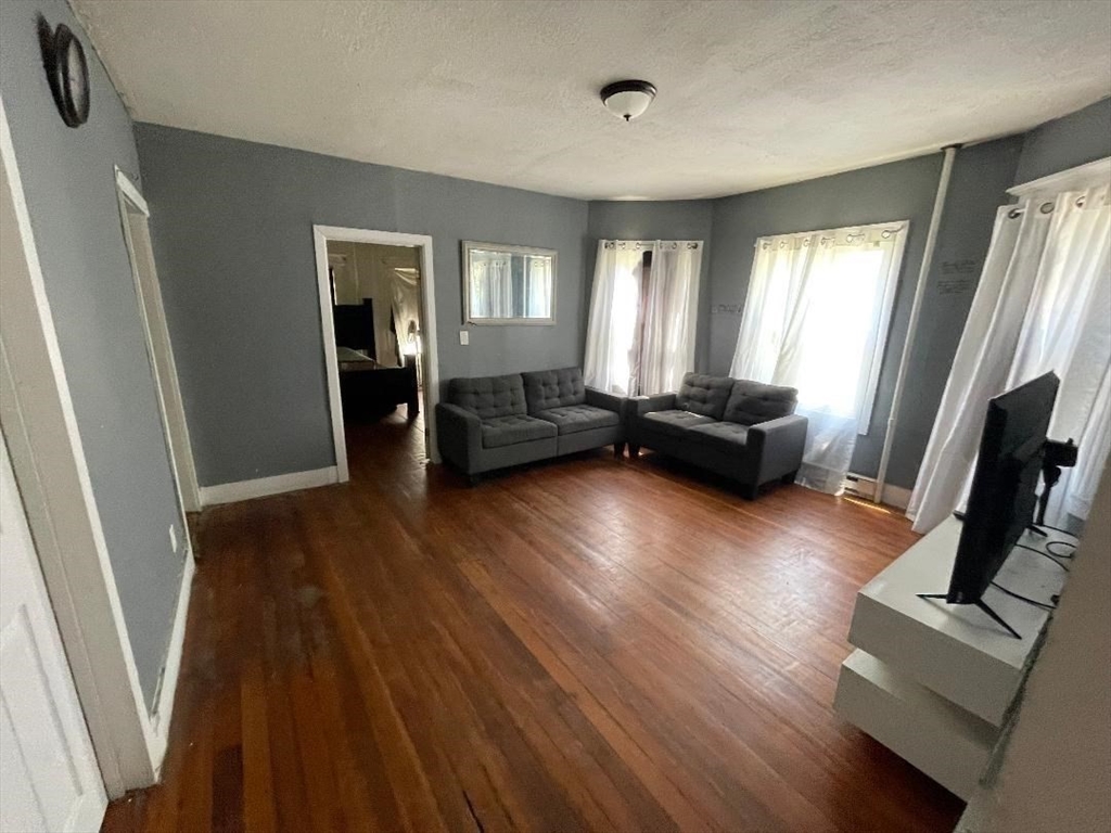 79 Keith Street Springfield, MA 01108 - Photo 23 of 37 a living room with furniture and a flat screen tv