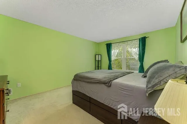 a bed sitting in a bedroom next to a window