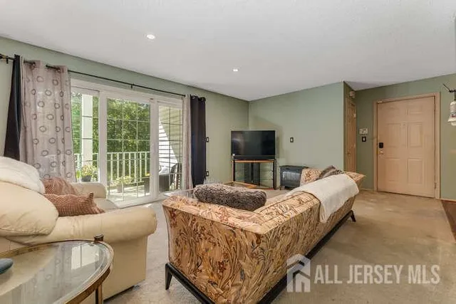 a bedroom with bed and glass door