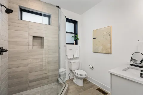 a bathroom with a toilet sink and shower