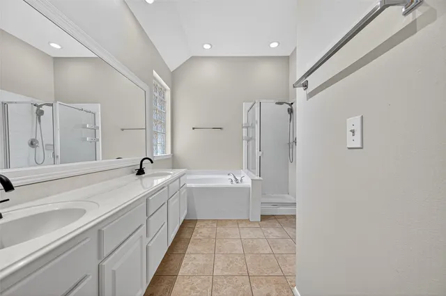 a bathroom with a tub sink and mirror