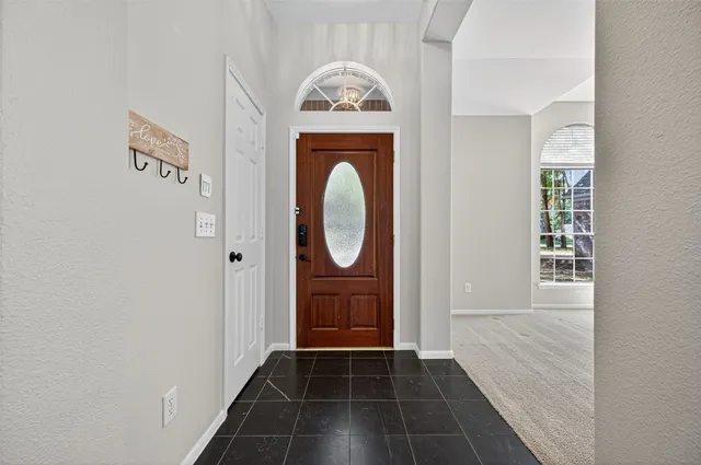 a view of a entryway door with wooden floor