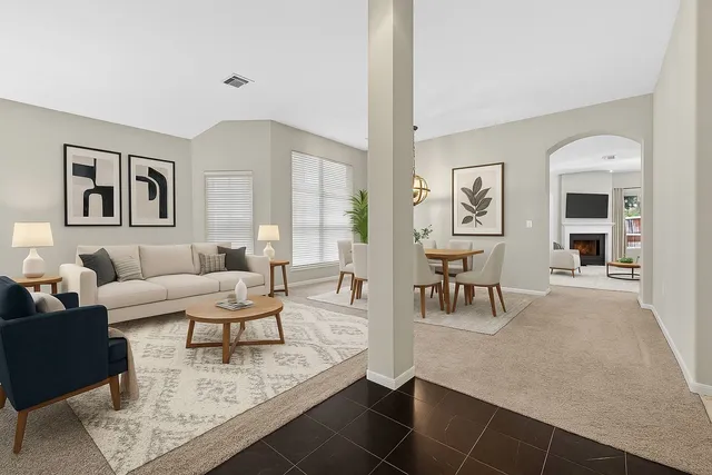 a living room with furniture and wooden floor