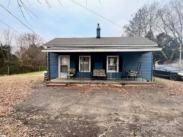 a view of a car park in front of the house