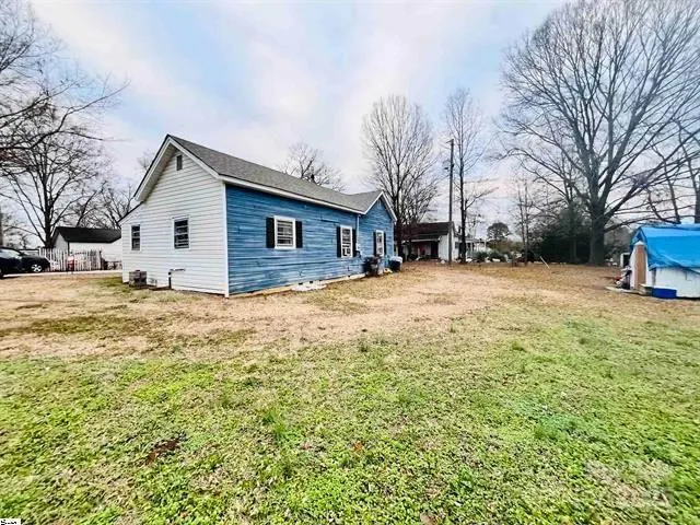 a large house with a large tree in front of it