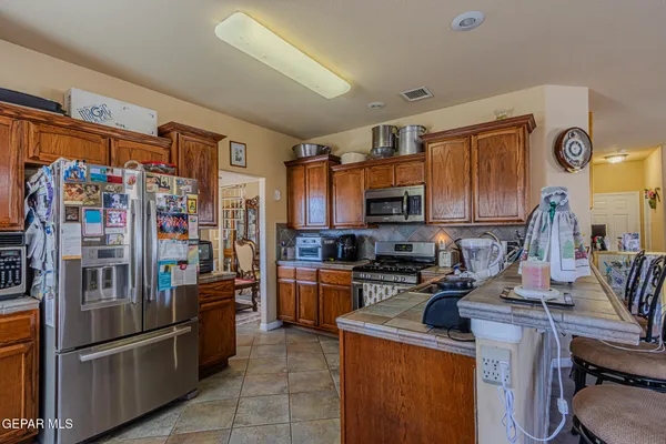 a kitchen with stainless steel appliances granite countertop a stove and a sink