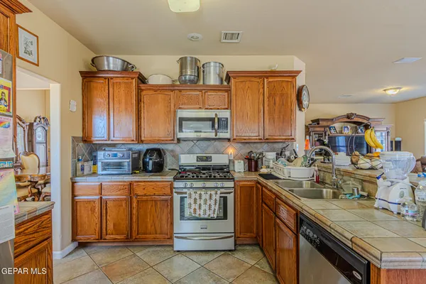 a kitchen with lots of counter top space and wooden floor