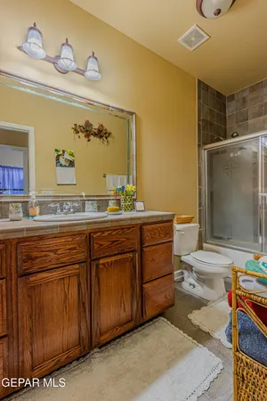 a bathroom with a sink mirror toilet and bathtub