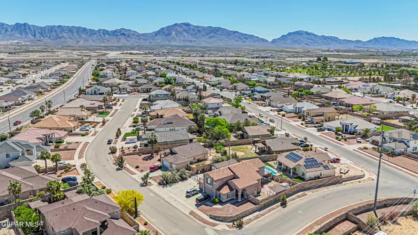 an aerial view of residential building and sandy dunes