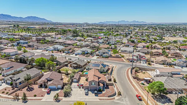 an aerial view of residential houses and car parked