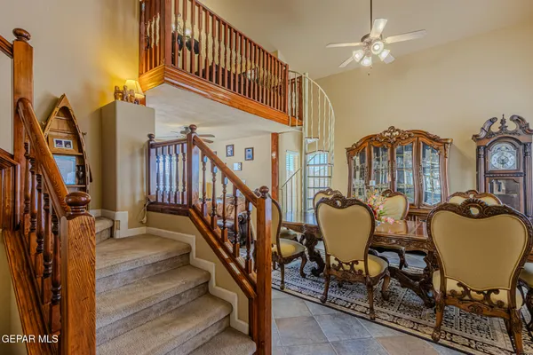 a view of a dining room with furniture and a chandelier