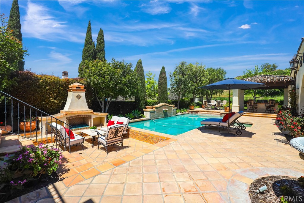 59 Canyon Creek Irvine, CA 92603 - Photo 51 of 65 back yard showing outdoor fireplace, pool, spa and covered outdoor bbq in distance