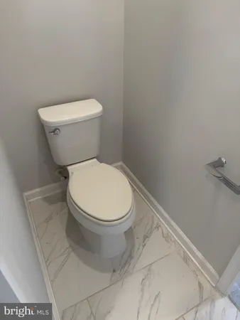 a white toilet sitting next to a white sink