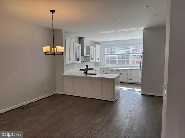a large kitchen with kitchen island a large counter top space a sink and appliances