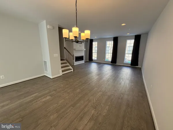 a view of a room with wooden floor and windows