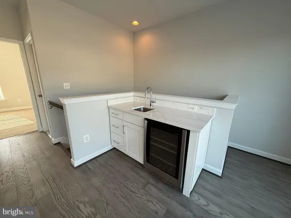 a kitchen with a stove and a wooden floors