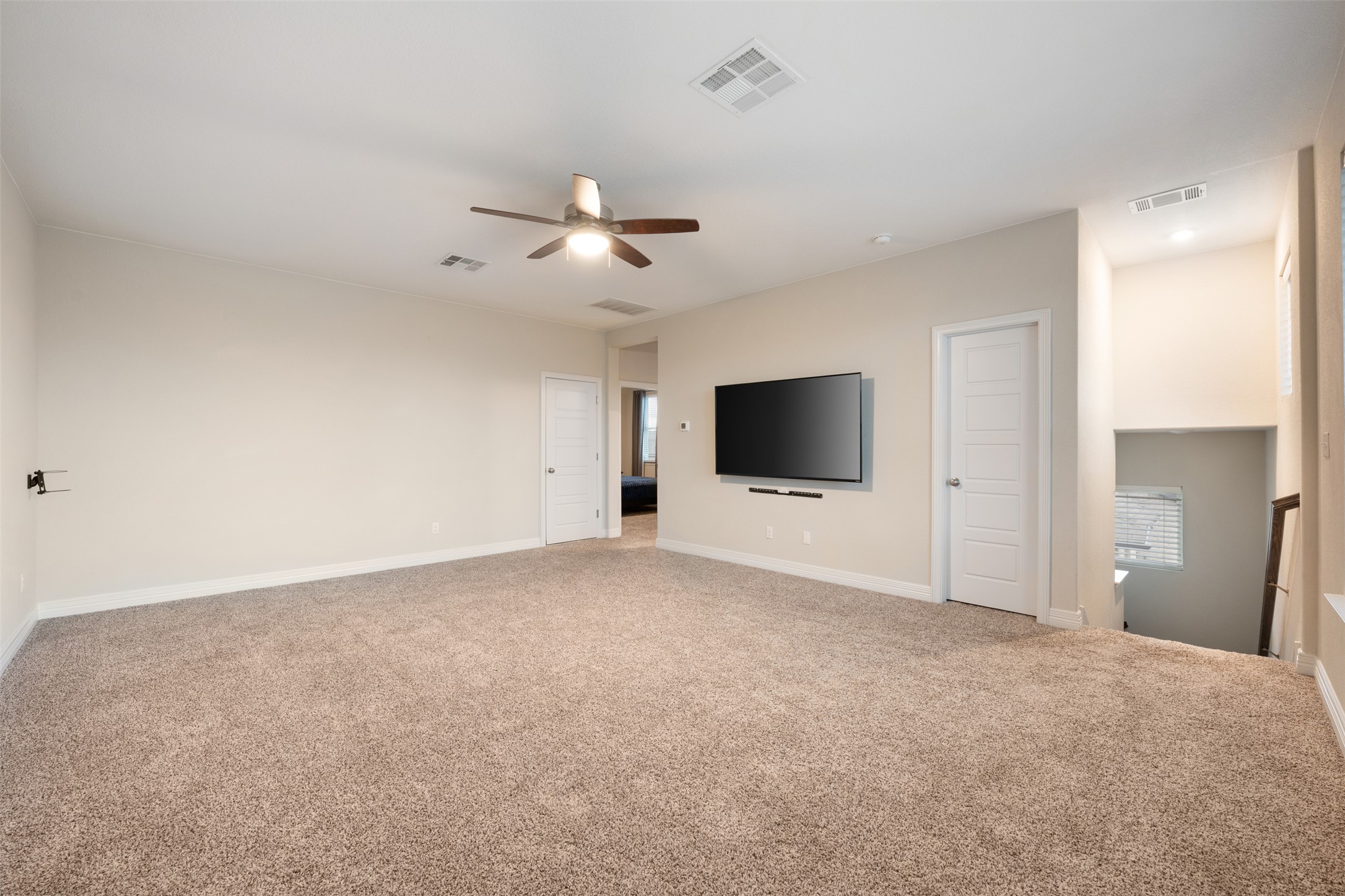 2501 Costera Street Leander, TX 78641 - Photo 19 of 40 Unfurnished living room with carpet floors and a ceiling fan