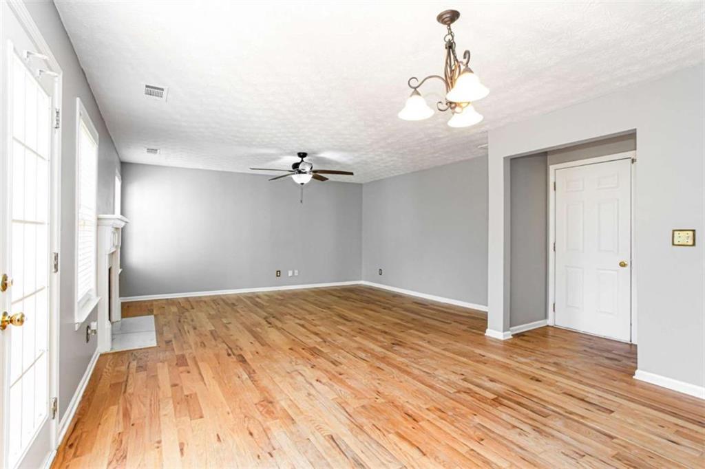 3721 Bogan Mill Road Northeast Buford, GA 30519 - Photo 9 of 58 a view of empty room with wooden floor