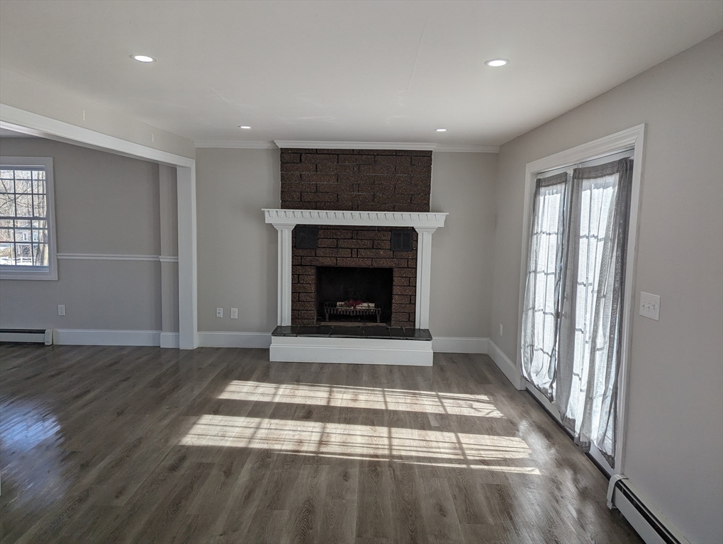 35 Carter Road Westminster, MA 01473 - Photo 5 of 20 an empty room with wooden floor fireplace and windows