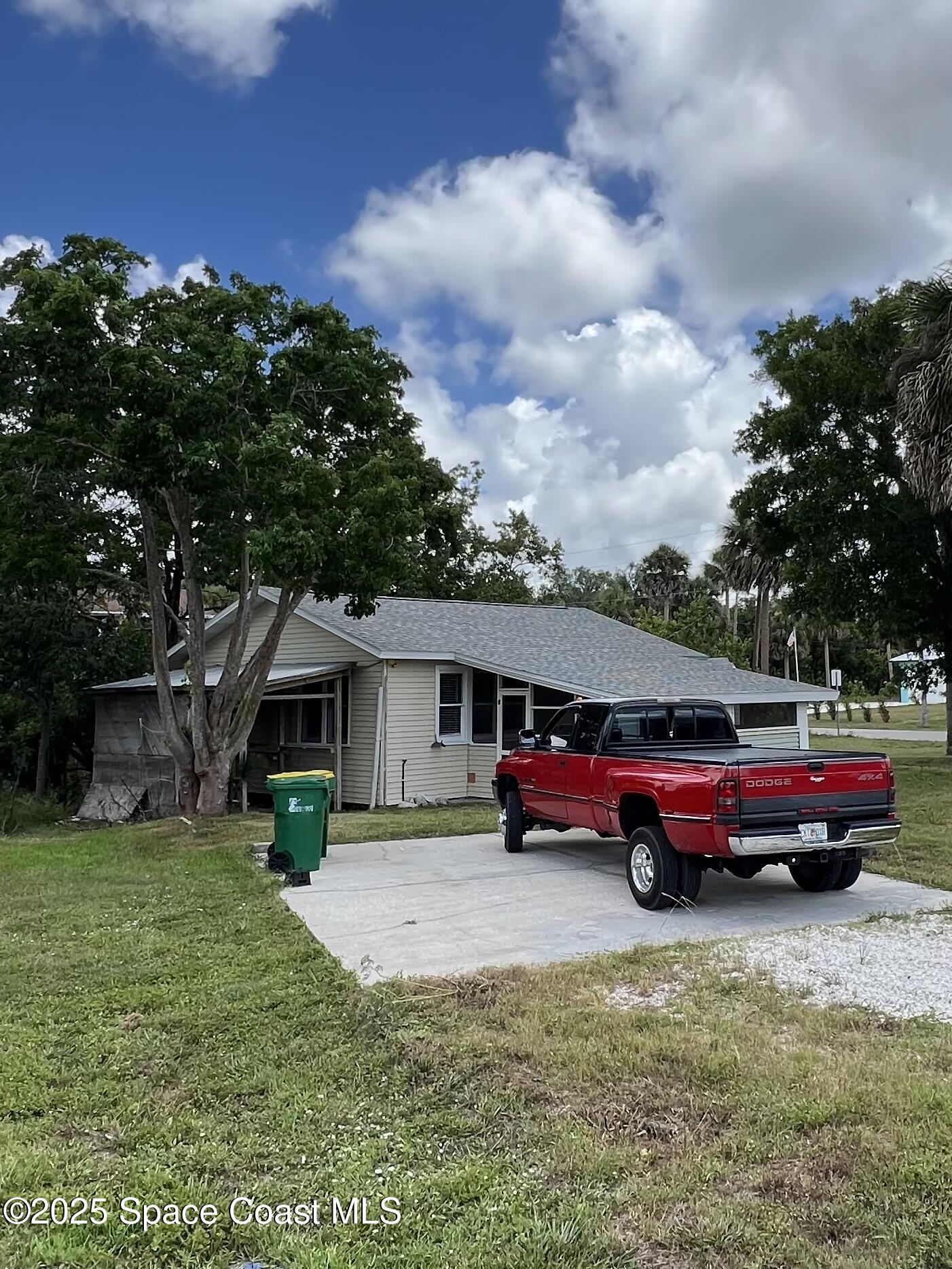 6500 June Drive Cocoa, FL 32926 - Photo 1 of 21 a yellow house with trees in front of it