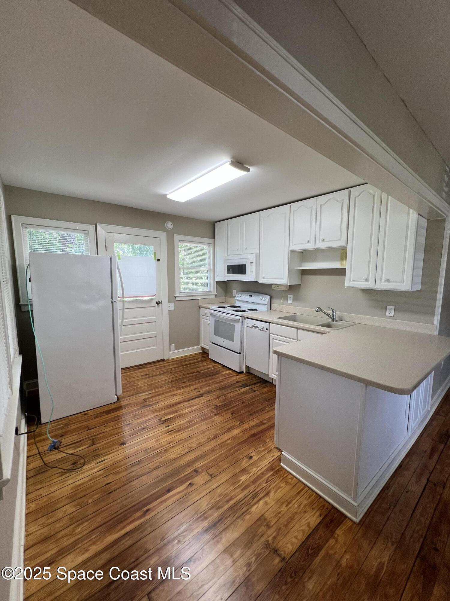 6500 June Drive Cocoa, FL 32926 - Photo 8 of 21 a kitchen with stainless steel appliances granite countertop a stove a sink and a refrigerator