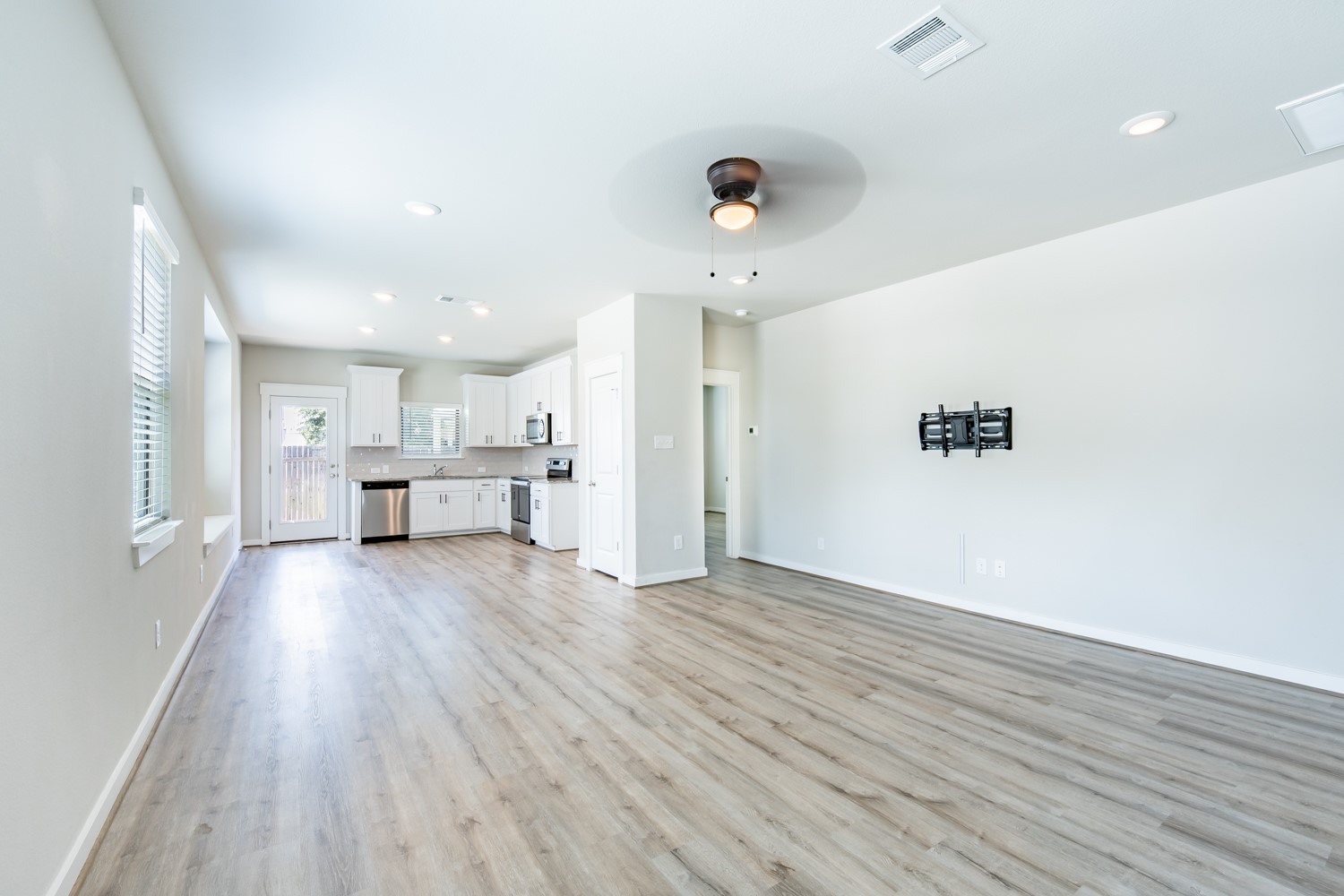 147 Waterside Road, Unit A Buda, TX 78610 - Photo 27 of 27 An open floorplan seamlessly connects the kitchen and living areas, offering effortless daily living.