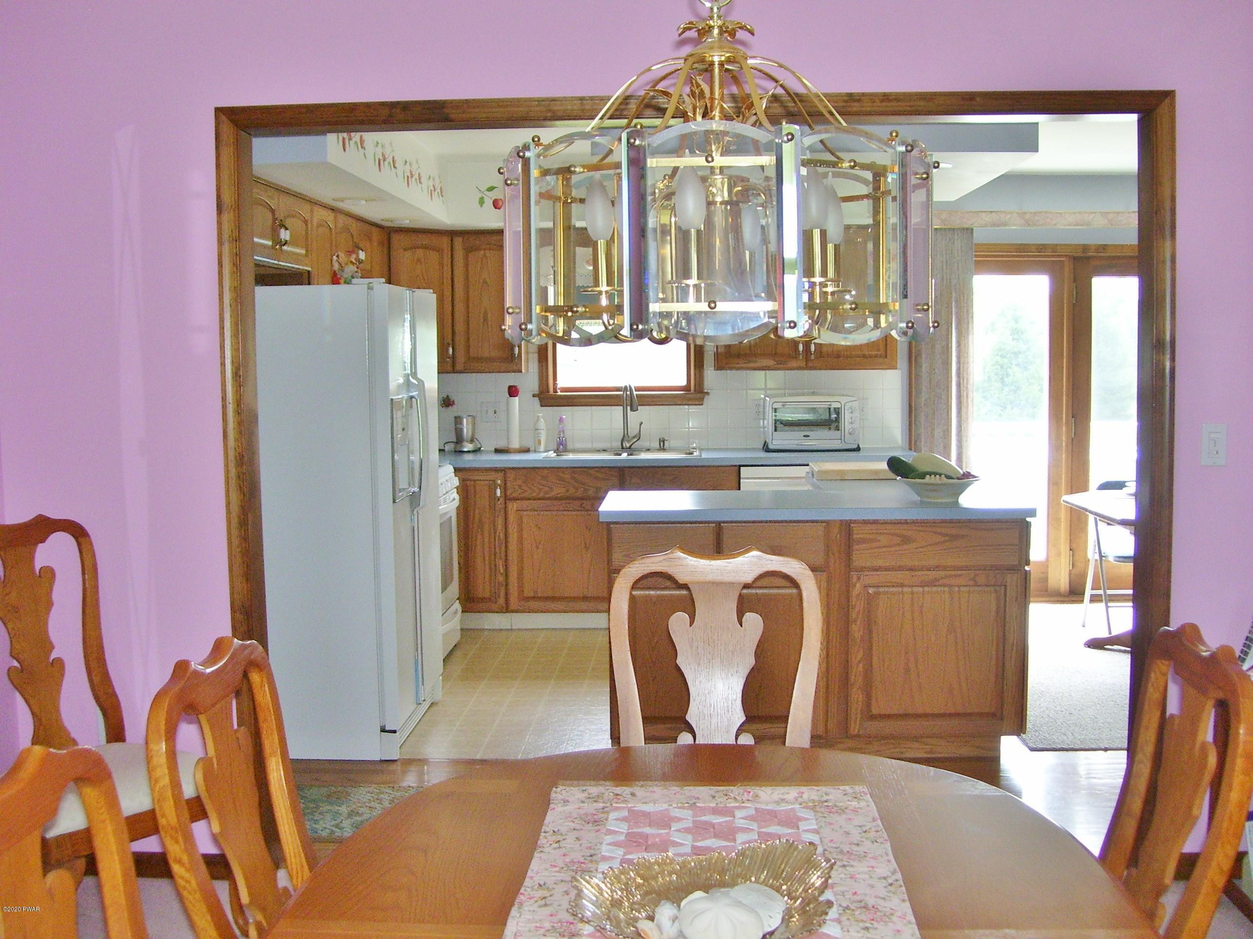 50 Layton Road Waymart, PA 18472 - Photo 13 of 61 a view of a kitchen with a dining table and chairs