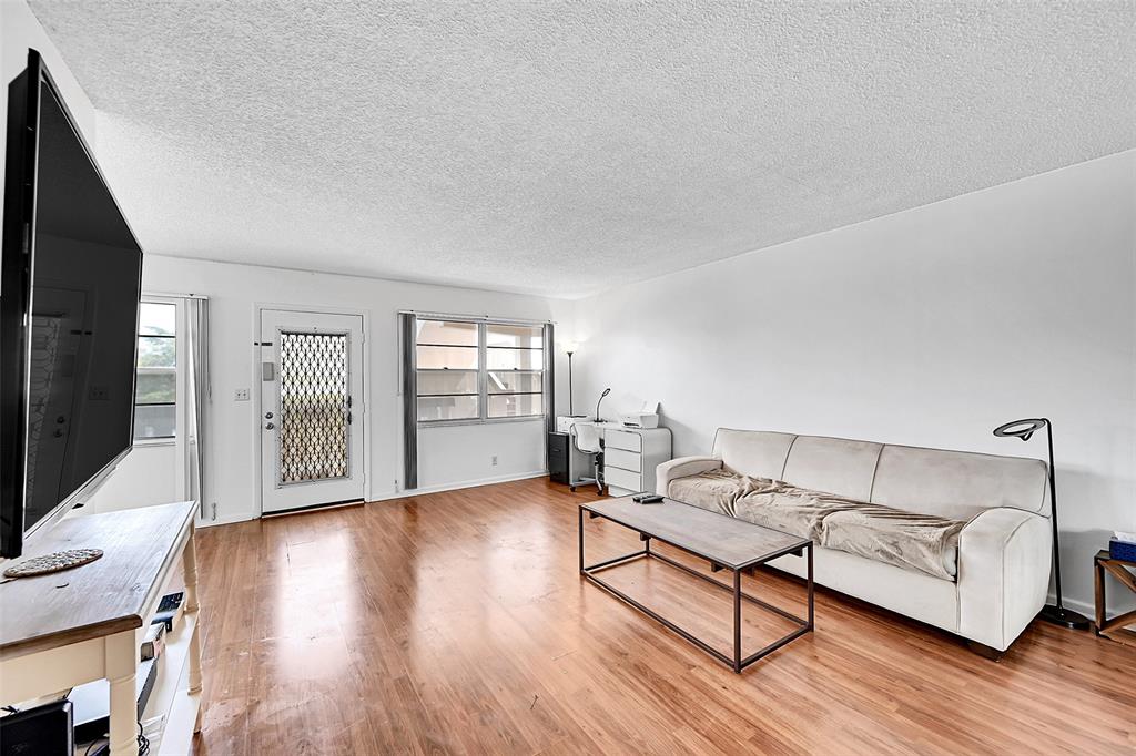 1901 Bermuda Circle, Unit L3 Coconut Creek, FL 33066 - Photo 12 of 27 a living room with furniture and a flat screen tv