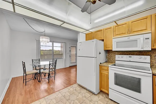 a kitchen with furniture and wooden floor