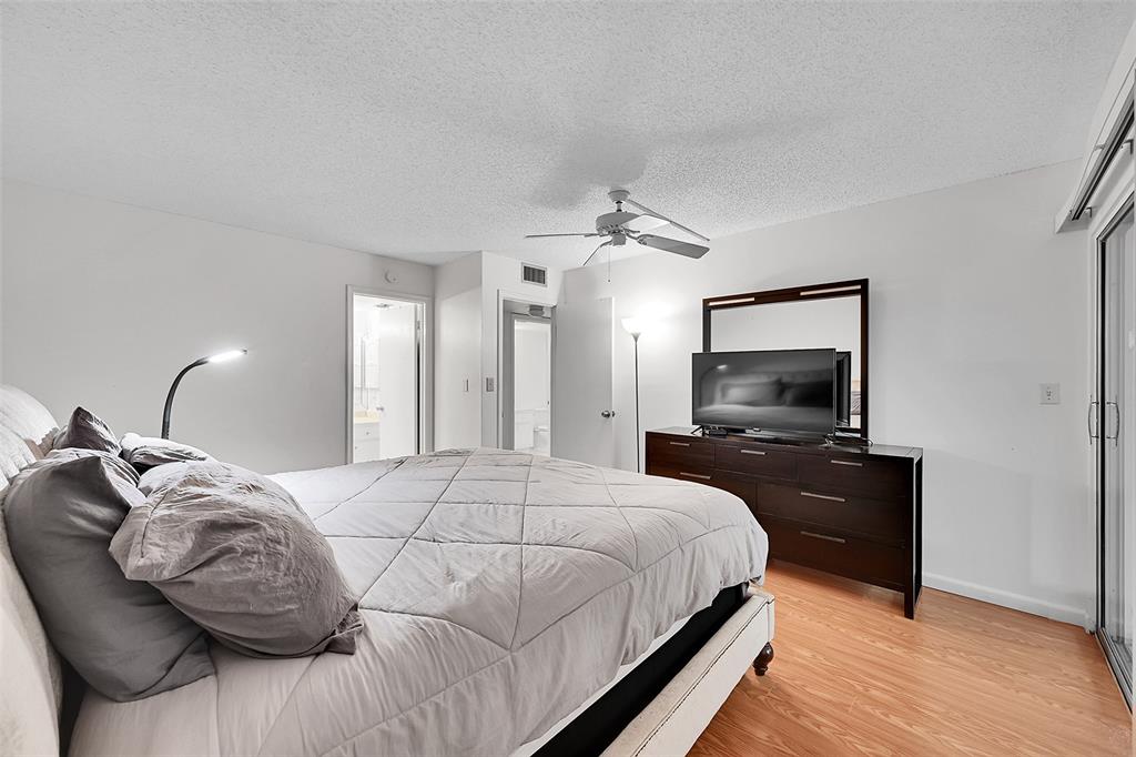 1901 Bermuda Circle, Unit L3 Coconut Creek, FL 33066 - Photo 18 of 27 a bedroom with a bed and a flat screen tv