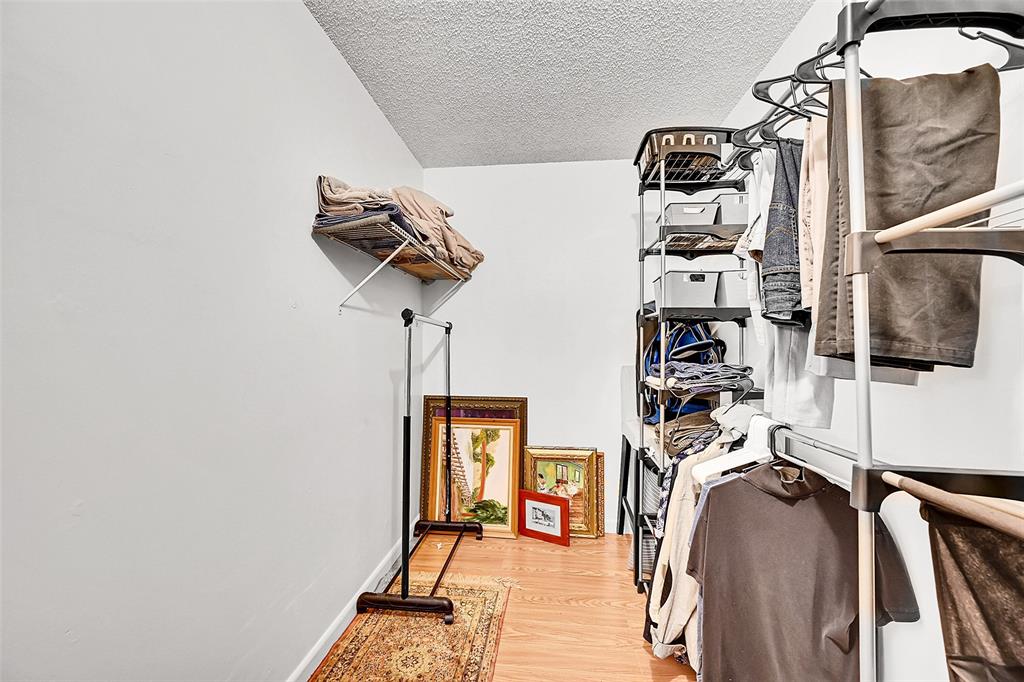 1901 Bermuda Circle, Unit L3 Coconut Creek, FL 33066 - Photo 19 of 27 a view of walk in closet with clothes and shoes