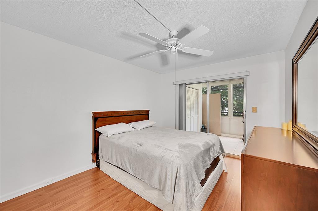 1901 Bermuda Circle, Unit L3 Coconut Creek, FL 33066 - Photo 6 of 27 a bedroom with a bed and wooden floor